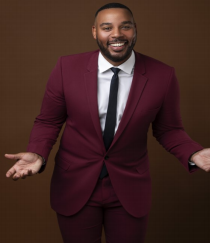 Christian Hill man standing in suit smiling at camera