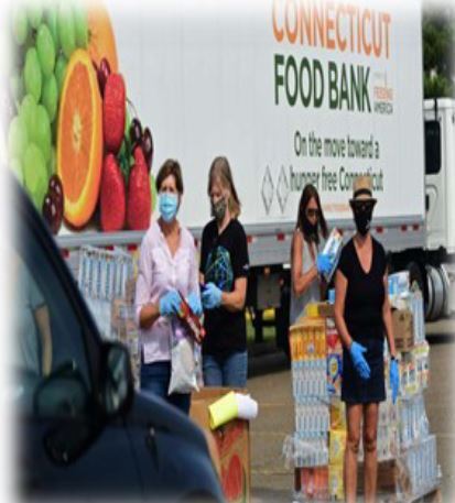 people with masks in front of food truck distributing food