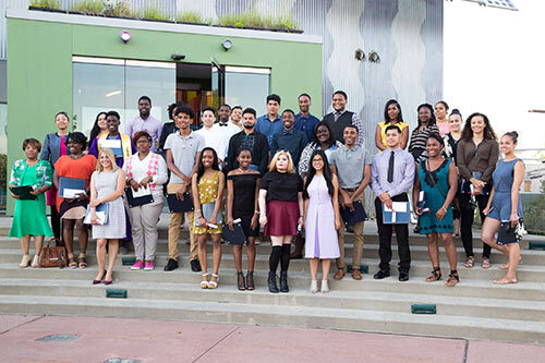 2017 graduation class group pose outside of building on stairs