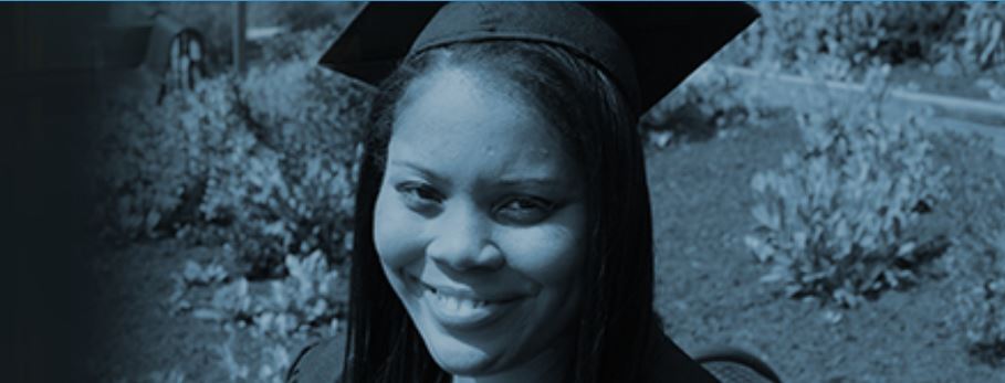 young lady with cap and gown outside