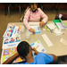 2 kids 1 boy and 1 girl at table working on homework