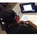 Student at table with computer using earphones