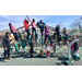 2 classroom of many students outside on playground equipment with teacher