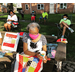 Senior women sitting outside on the grass by their residences working on quilts