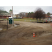 Tire tracks crossing back and forth in the dirt as construction begins