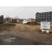 Piles of dirt to the right of the dirt road as construction begins