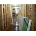 Sheetrock stacked to the side as workers continue construction inside the building