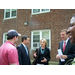 Group of 3 men and one woman speaking