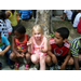 children sitting at base of tree