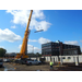 A crane lifts steel beams into place 