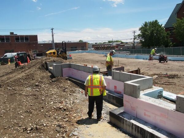 Construction workers start laying out the building footprint