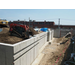 bobcat pushing dirt up foundation wall