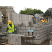 Workers are laying concrete bricks