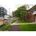 Construction site is to the right of the chain link fence