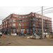 Construction outside the building continues, scaffolding is on the right side 