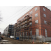 Construction outside the building continues, scaffolding reaching up to the 3rd story