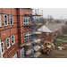 Construction outside the building continues, scaffolding reaching up to the 3rd story