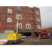 Workers continue construction on the outside of the building