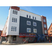 Workers continue to put the white and blue siding on the outside of the building