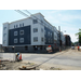 Workers have completed the siding on 2 sides of the building