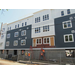 Workers continue to put siding on the building