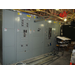 Metal pipes stacked in front of an electrical panel 