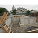 Wooden ladder going over concrete foundation