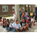 Children sitting around a tree