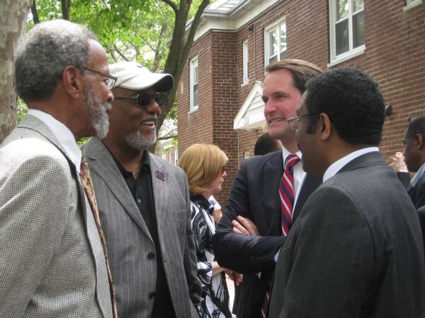 Four men in a circle talking