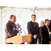 Man smiling addressing crowd