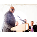 Man with sunglasses speaking at the podium