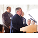 Man in overcoat speaking at the podium