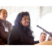 Woman with sunglasses on her head speaking at the podium