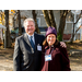 Man with arm around woman's shoulder, both smiling