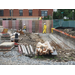 three people working on concrete wall