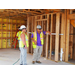 Two construction workers discussing building plans 