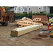 A forklift drops off a load of wood