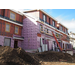 The second layer of sheathing is going up on the outside of the building