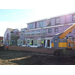 Workers put up siding on the outside of the building