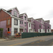 Workers put up siding on the outside of the building and lower story windows are being installed