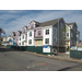 White and green siding is going up on the outside of the building