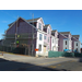 Workers continue to put up siding on the outside of the building