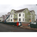 White and green siding is going up on the outside of the building